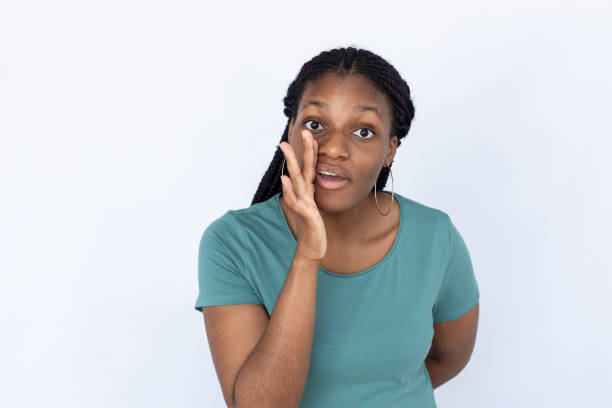 istock Surprised woman holding hand at mouth 1440072886