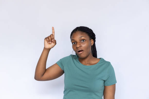 istock Surprised woman pointing up 1440072888