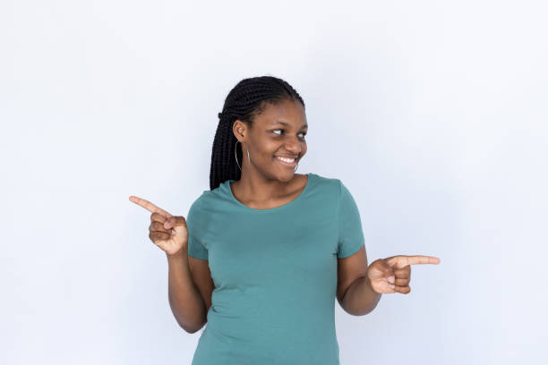 istock Pleased woman pointing at different sides 1440072899