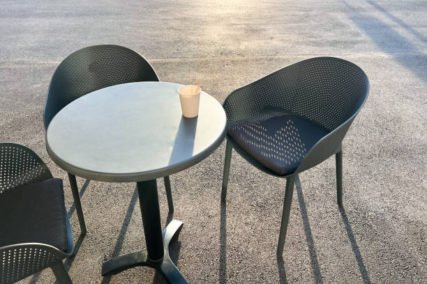 istock Coffee table and chairs outdoors, paper coffee cup on the table 1440073439