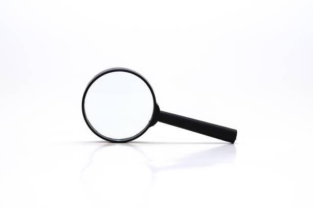 istock Loupe or magnifying glass on white. Shallow depth of field 1440081204