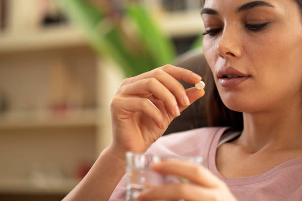 istock young woman getting medicine pill 1440092574