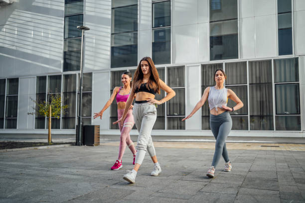 istock Young women dancing outdoors 1440093884