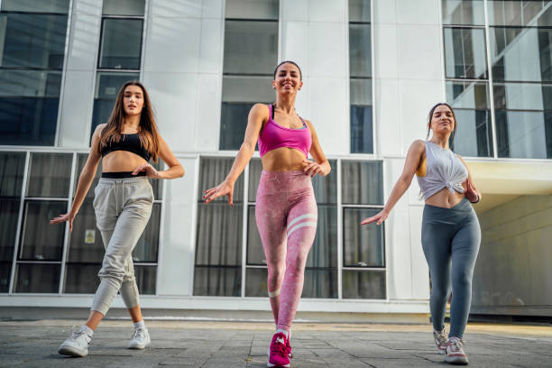 istock Young women dancing outdoors 1440093908