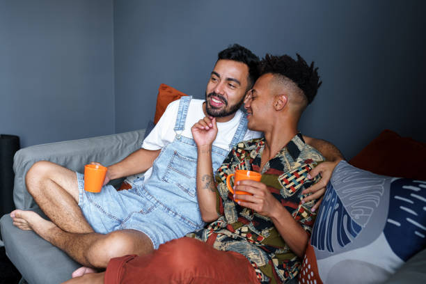 istock Happy couple sitting on sofa dating 1440095113