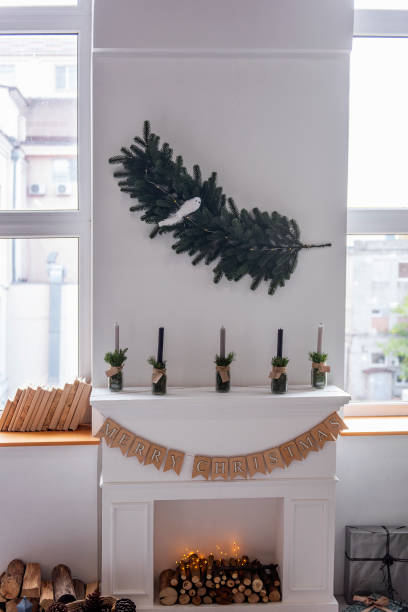 istock Minimalistic Christmas decoration by the fireplace. Scandinavian rustic interior style. 1440095502