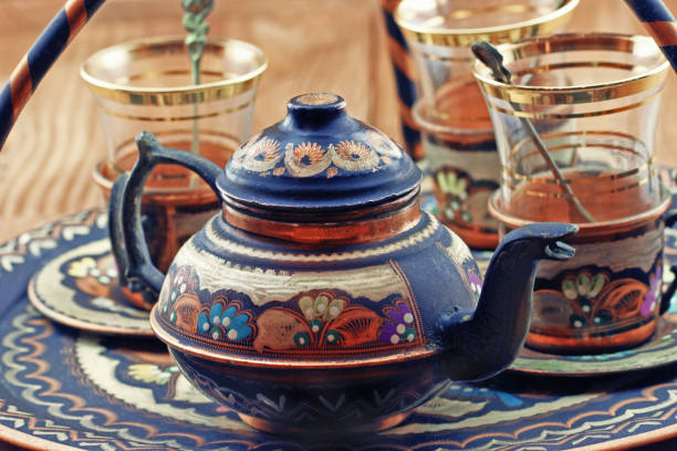 istock Turkish tea set: vintage glass cups with teapot on the plate 1440095928