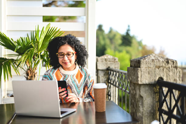 istock woman using laptop at the bar. 1440097401
