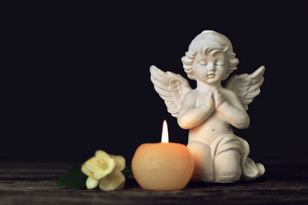 istock Angel, white flowers and burning candle 1440098548