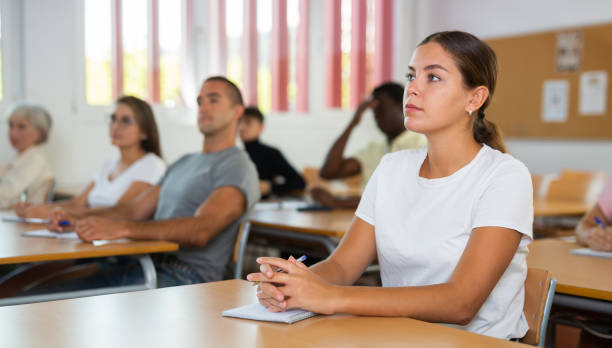 istock Young woman attending lecture in classroom 1440098852
