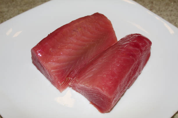 Sliced raw tuna on a white plate