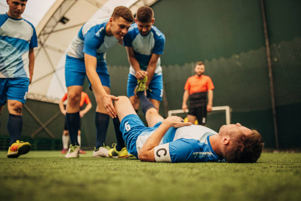 istock Soccer player helping his injured teammate 1440101011