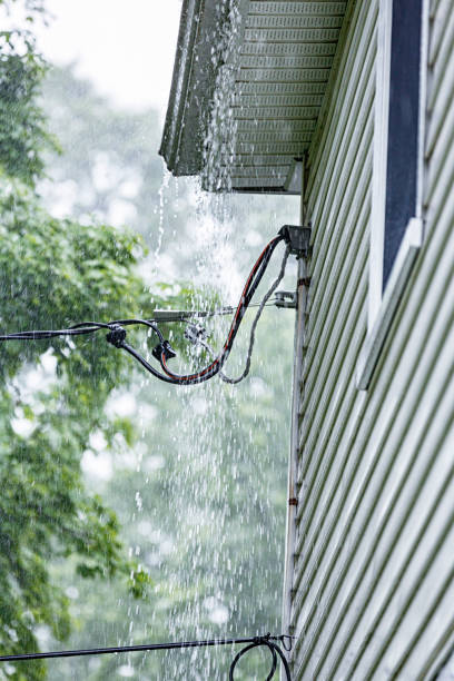 istock Drenching Rain Storm Downpour Water Gushing From Roof Edge 1440101597