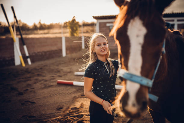 istock A girl brushes her horse 1440102817