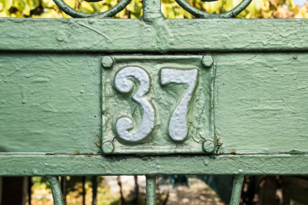 Old retro cast iron plate number 37 Old retro weathered cast iron plate with number 37 closeup number 37 stock pictures, royalty-free photos & images