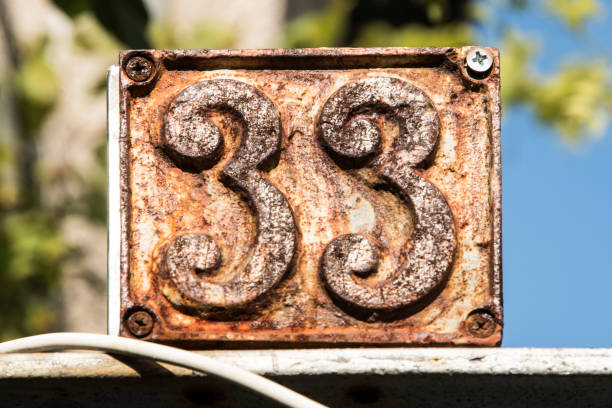 istock Old retro cast iron plate number 33 1440102997
