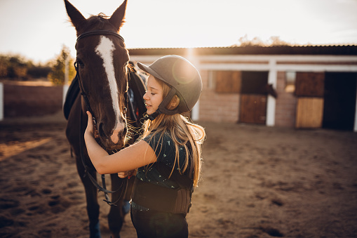 Happy, nature and child with a horse in a forest training for a race, competition or event. Adventure, animal and young girl kid with stallion pet outdoor in the woods for equestrian practice.