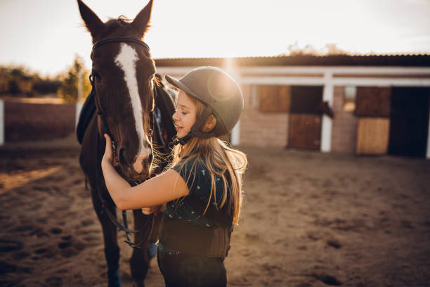A girl hugs her horse stock photo