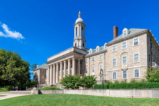 The Old Main building on the campus of Penn State University in sunny day in State College, Pennsylvania.