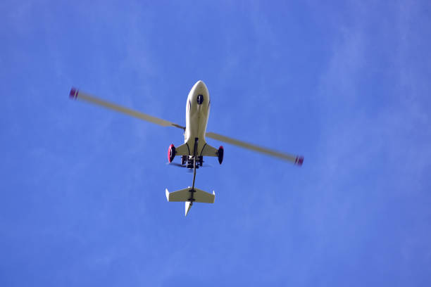 istock Gyrocopter flying with background of blue sky 1440105995