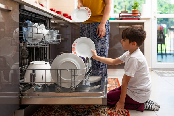 istock Mother and son washing dishes. 1440107927