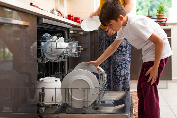 istock Mother and son washing dishes. 1440107970