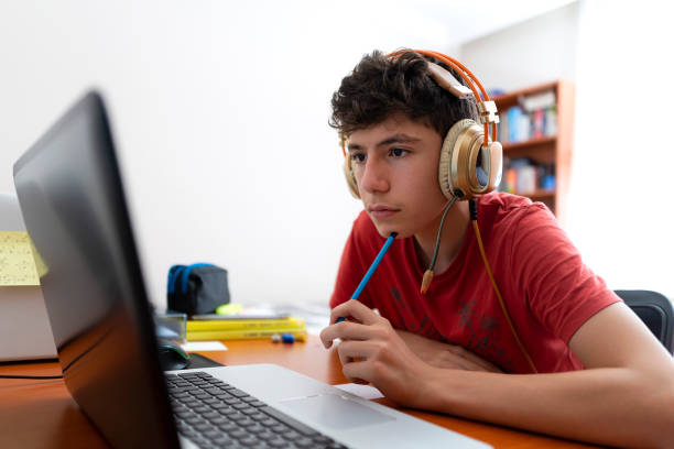 istock Teenage boy is studying via pc. 1440109794