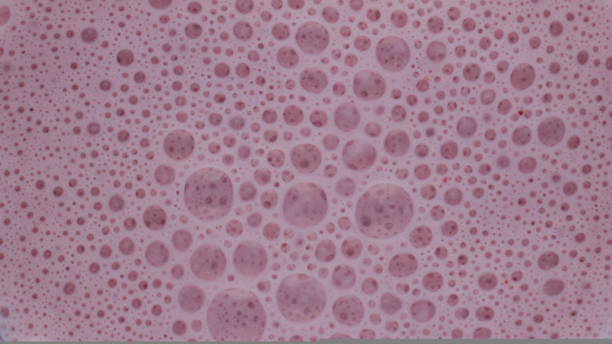 istock Closeup berry smoothie bubbles inside blender. Top view tasty fruit cocktail. 1440110788