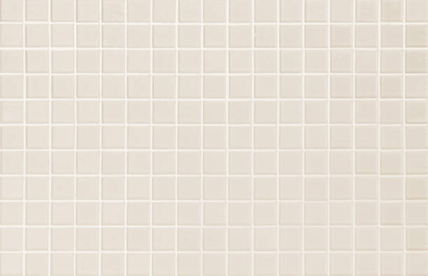 istock Cream light ceramic wall and floor tiles mosaic background in bathroom and kitchen. Design pattern geometric with grid wallpaper texture decoration pool. Simple seamless abstract surface clean. 1440110844