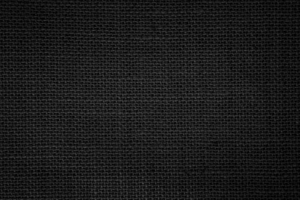 istock Black fabric canvas texture background. Linen dyed black. Sackcloth woven texture pattern background dark black color pipe from plant blade natural. Abstract vintage textured empty. 1440111063