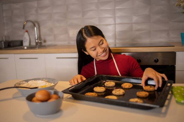 istock Young woman making cookies 1440111659