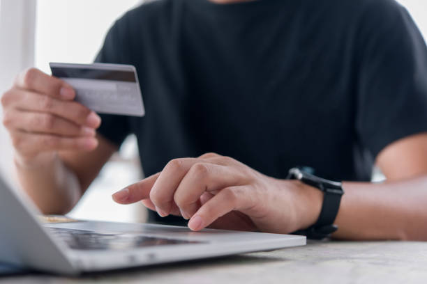 istock Online shopping e-commerce or internet banking concept.Man hand holding credit card and using laptop.Business finance payment and accounting. 1440111744