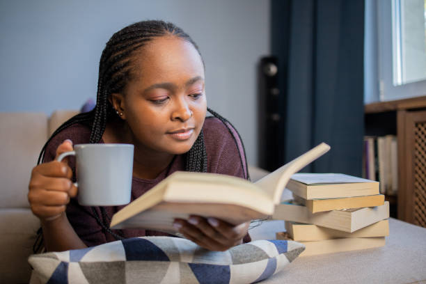 istock Woman relaxing and reading a book 1440111835