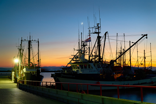 Commercial fishboats at the dock at twilight. Steveston, British Columbia. November 10, 2018.