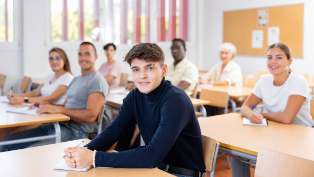 istock Positive young man attending lecture in college 1440126497
