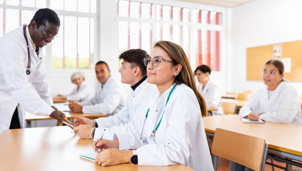 istock Portrait of doctors different age who writing exercises at lesson 1440126516