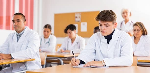 istock Portrait of doctors different age who writing exercises at lesson 1440126526