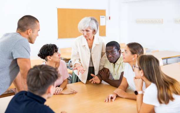 istock Elderly teacher, together with students of different ages, conducts round-table classes in university auditorium 1440126557