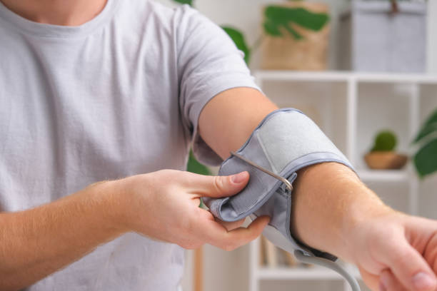 istock A man measures blood pressure with a white electric tonometer lying on a white table. Hypertension 1440128468