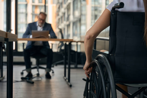 istock Female with disability coming to work in office 1440128689