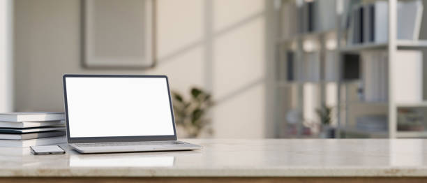 istock Modern workspace tabletop with laptop mockup and copy space over blurred modern urban bright office 1440130122