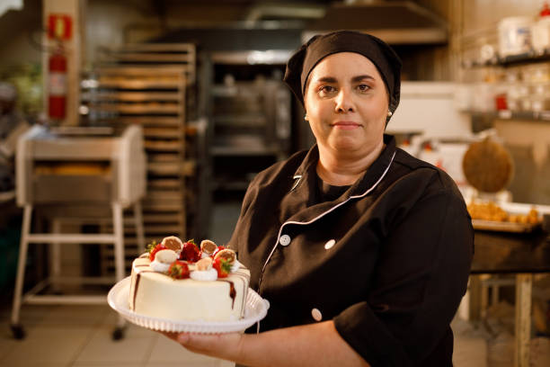 Pastry chef showing a chocolate and strawberry cake