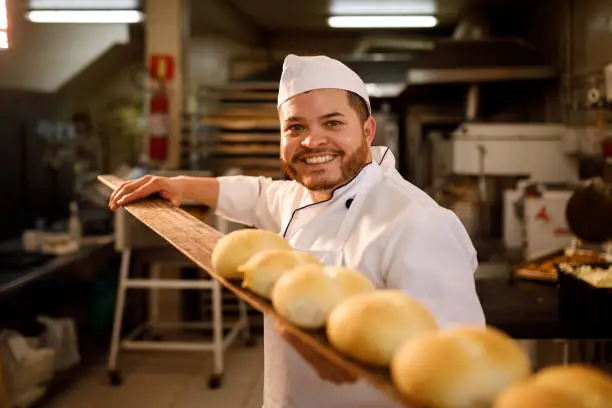 Photo of Smiling baker with freshly baked bread