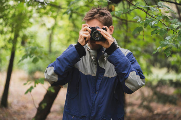 istock hipster making photo using old vintage camera outdoors 1440132383