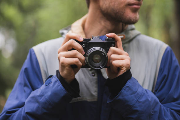 istock hipster making photo using old vintage camera outdoors 1440132387