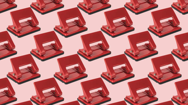 istock A pattern of red hole punches on a light pink background. 1440133237