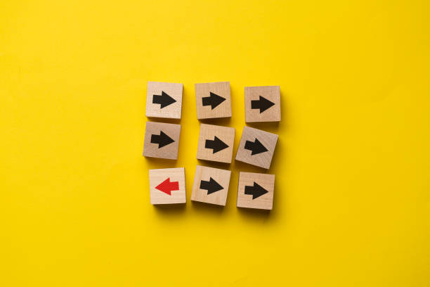 istock nine wooden cubes with arrows, unique concept, arrow change direction 1440133716