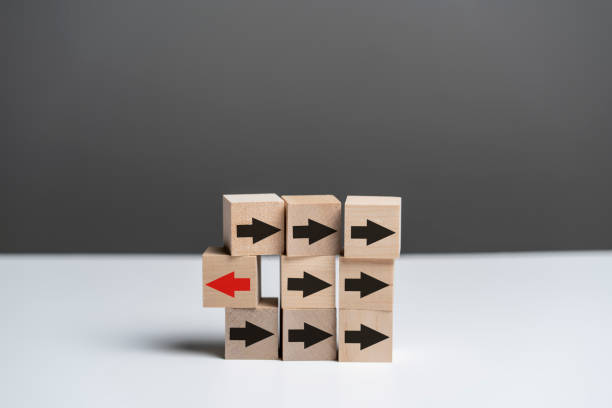 istock nine wooden cubes with arrows, unique concept, arrow change direction 1440133722