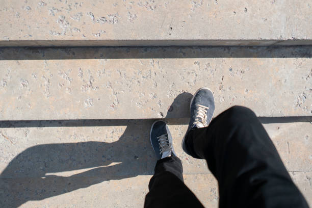person's foot making a step on the stairs