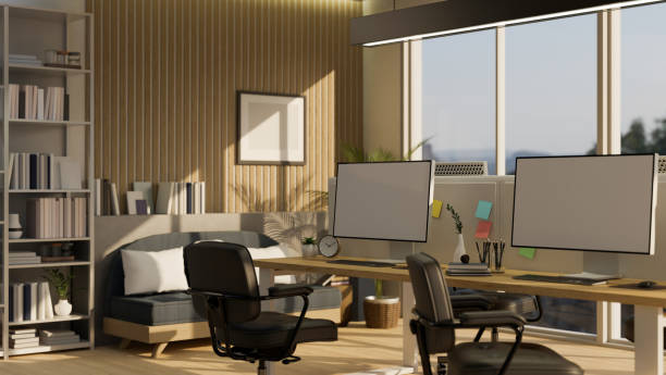istock Modern study room with blank screen PC desktop computers on wooden table with stationary 1440133949